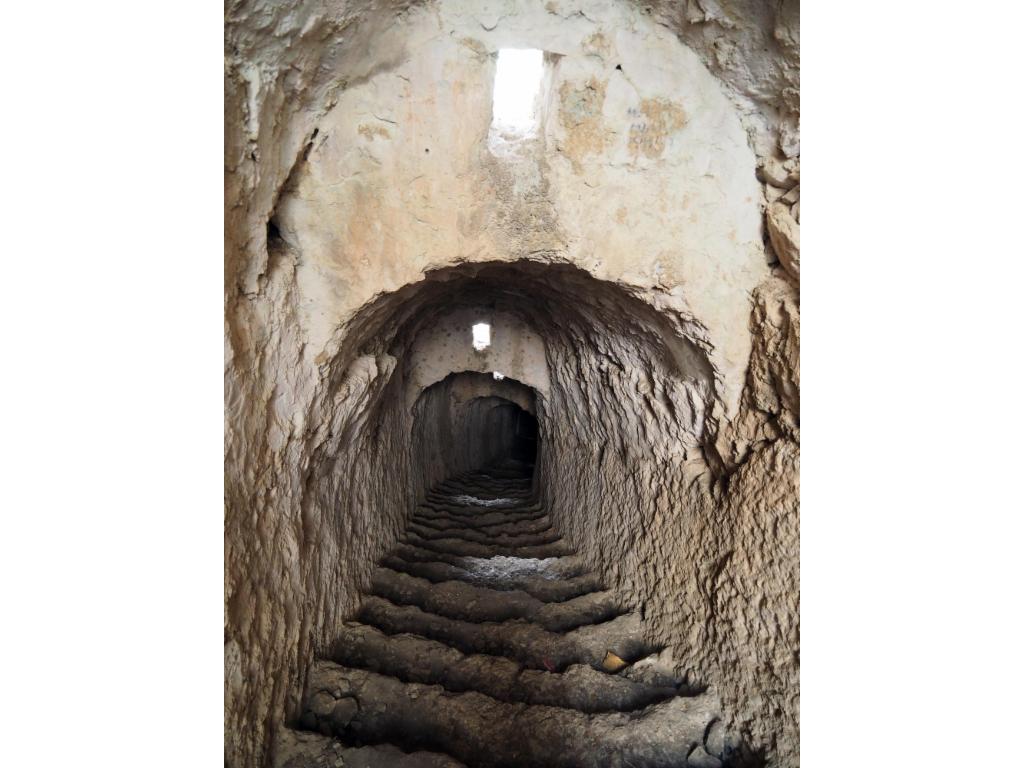 Steep stairs in a tunnel through the lower rock barrier