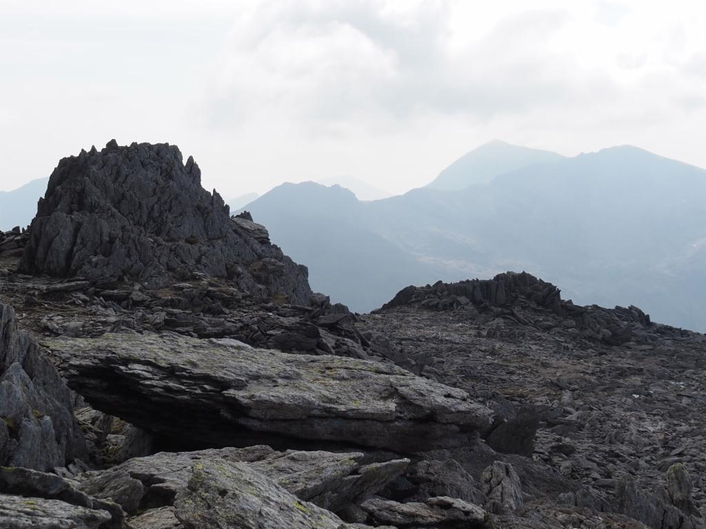 Summit rock of Glyder Fawr and Mount Snowdon in the background