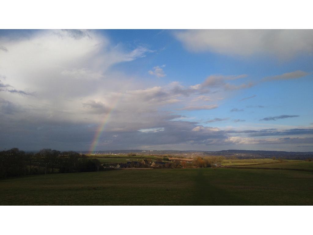 Rainbow over Oxford's spires and cranes from Boars Hill