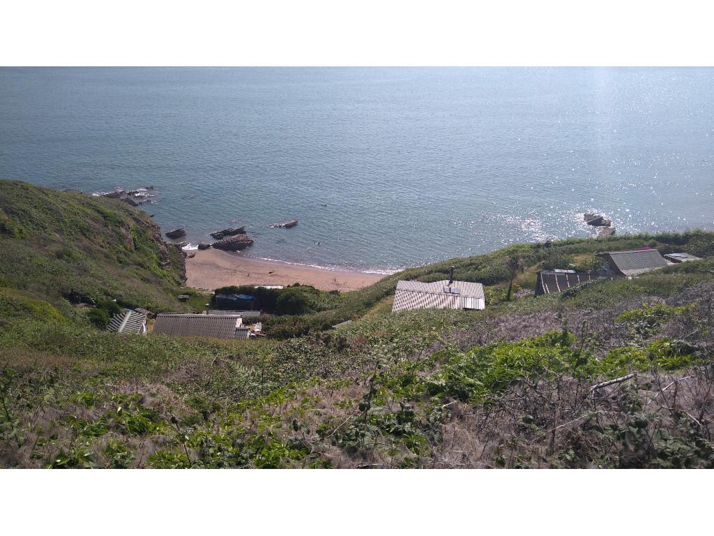 Chalets scattered along the steep coast line