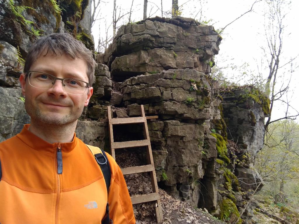 The final escarpment is conquered via a wooden ladder.