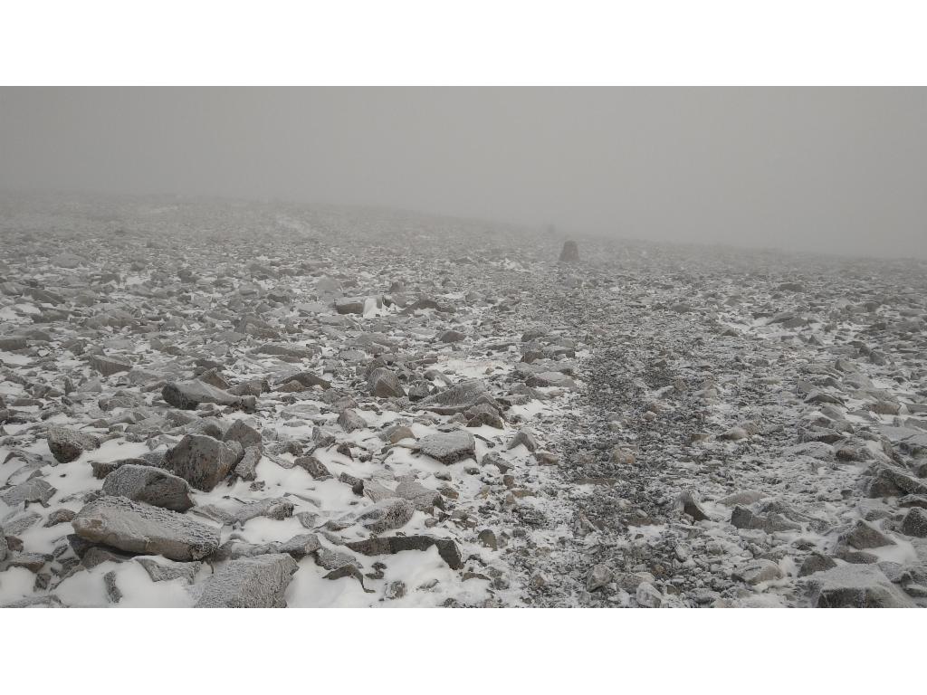 Crossing the summit plateau from cairn to cairn